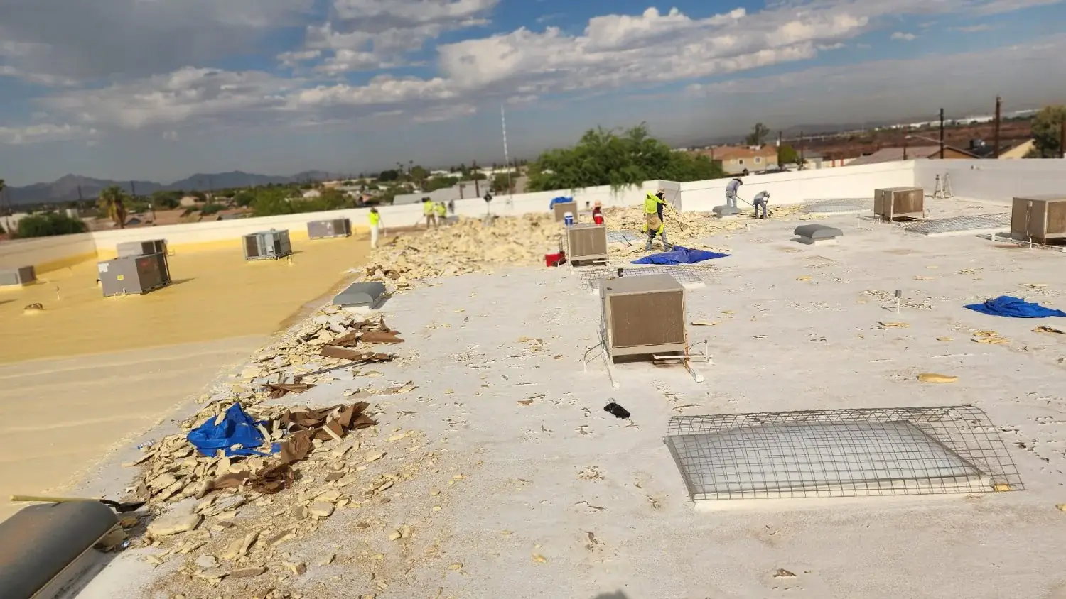 Debris cleared during a commercial flat roof tear-off