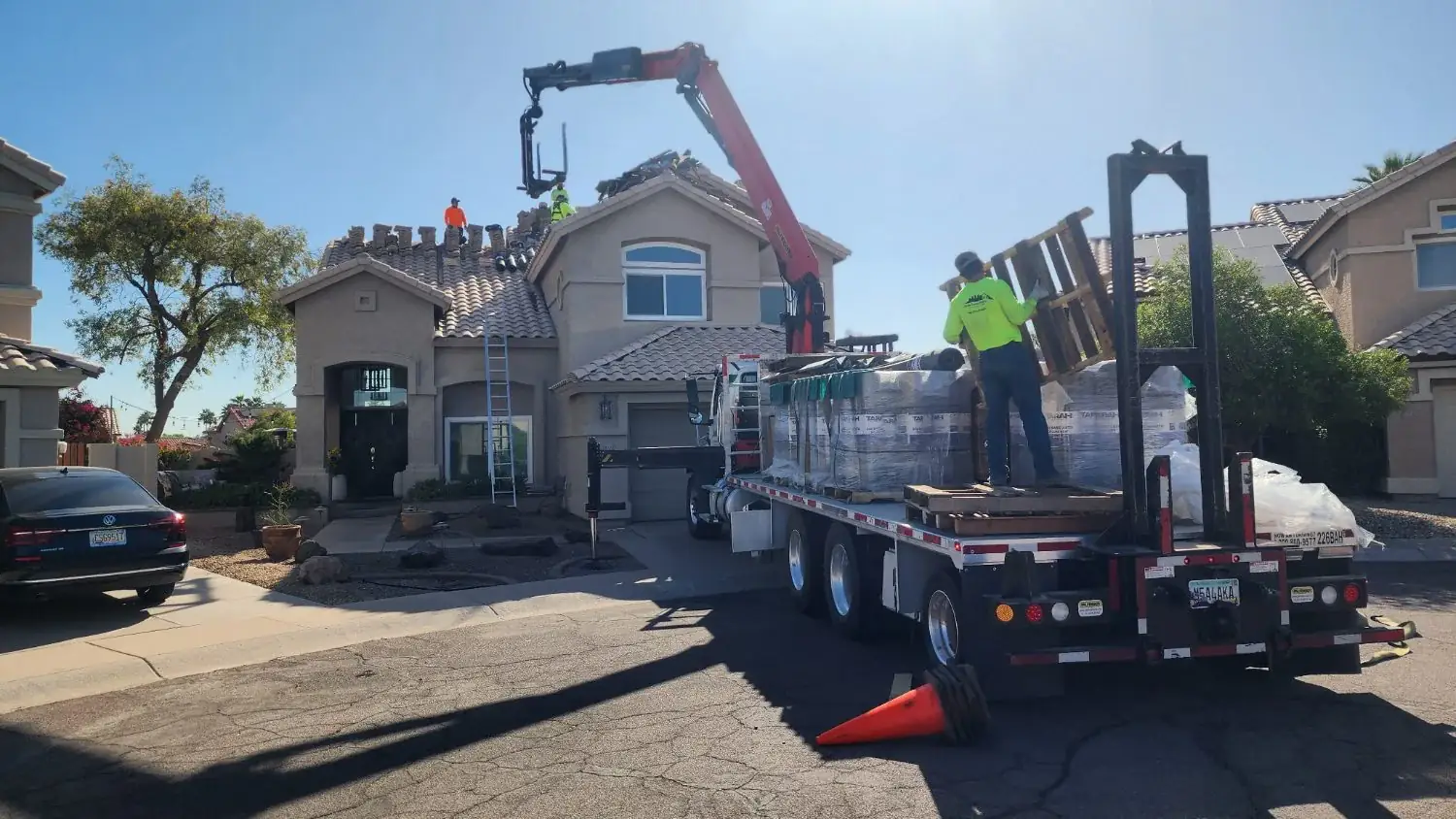 Hero photo: tile delivery and crew on an East Valley roof replacement